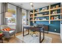 Stylish office featuring custom shelving, a modern desk, and comfortable seating area at 19426 W San Juan Ave, Litchfield Park, AZ 85340