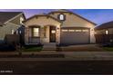 Exterior view of a cozy home with a beautiful entrance and a well-lit driveway at 20073 S 231St Pl, Queen Creek, AZ 85142