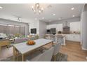 Bright, open-concept living and dining area with modern decor and sleek kitchen at 20073 S 231St Pl, Queen Creek, AZ 85142