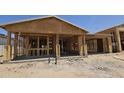 Image shows a home under construction with exposed framing and blue sky at 32101 N Lone Rancher Way, San Tan Valley, AZ 85140