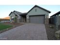 Craftsman-style home featuring a spacious driveway and attached two-car garage at 32541 N 135Th Dr, Peoria, AZ 85383