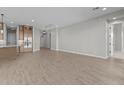 Bright and airy living room with tile floors, recessed lighting, and access to the kitchen at 32541 N 135Th Dr, Peoria, AZ 85383