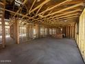 Interior view of home under construction showing exposed framing, concrete floor, and ceiling at 32637 N Newby Dr, San Tan Valley, AZ 85143
