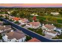 Aerial view of a residential neighborhood near a golf course and bodies of water in a suburban setting at 3665 S Jojoba Way, Chandler, AZ 85248
