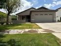 Well maintained single-story home featuring manicured lawn, attached two-car garage, and covered front porch at 3677 E Park Ave, Gilbert, AZ 85234