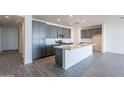 Modern kitchen with stainless appliances and gray cabinets at 39980 W Bunker Dr, Maricopa, AZ 85138