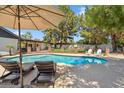 Inviting pool area with lounge chairs and a well-maintained deck at 401 E Braeburn Dr, Phoenix, AZ 85022