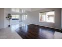 Bright and airy formal living room with hardwood floors, tile and large windows with natural light at 4306 E Raven Rd, Phoenix, AZ 85044