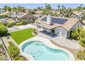 Aerial view of the home's backyard featuring a pool, solar panels, a covered patio, and artificial turf at 625 E Silver Creek Rd, Gilbert, AZ 85296