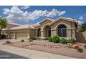 Charming single-story home featuring a neutral color palette and low-maintenance desert landscaping at 6388 W Donald Dr, Glendale, AZ 85310