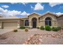 Charming single-story home featuring a neutral color palette and low-maintenance desert landscaping at 6388 W Donald Dr, Glendale, AZ 85310