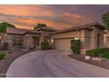 Beautiful home boasting a circular driveway, manicured landscaping, a two-car garage, and a stone accent wall at 712 W Jade Dr, Chandler, AZ 85248
