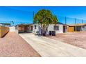 Exterior features a large driveway, desert landscaping, mature tree and covered parking at 7442 E Baseline Rd, Mesa, AZ 85209