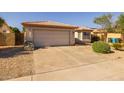 Single-Gathering home showcasing a driveway, well maintained desert landscaping, and a convenient two-car garage at 8952 W Monte Vista Rd, Phoenix, AZ 85037