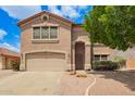 Charming two-story home featuring a well-maintained lawn, a two-car garage, and a welcoming entrance at 10566 E Bogart Ave, Mesa, AZ 85208
