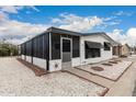 Beautiful exterior of a well-maintained home, featuring desert landscaping and a screened-in porch at 11000 N 91St Ave # 101, Peoria, AZ 85345