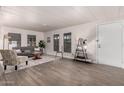 Well-lit living room featuring neutral walls, grey sofa, and light wood-look floors at 11000 N 91St Ave # 101, Peoria, AZ 85345