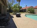This home offers an outdoor living space, complete with a patio, pool, and lush landscaping for tranquil enjoyment at 11106 E Clinton St, Scottsdale, AZ 85259