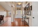 Welcoming foyer with high ceilings, wood floors, and art to give the home a sophisticated entry at 11106 E Clinton St, Scottsdale, AZ 85259
