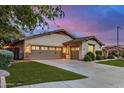 Charming house with well-kept lawn and large driveway leading to a spacious two-car garage at 12451 W Nadine Way, Peoria, AZ 85383