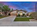 Single-story home with a well-maintained lawn, spacious driveway, and desert landscaping at 12451 W Nadine Way, Peoria, AZ 85383