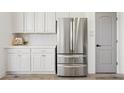 Clean white cabinets paired with stainless steel refrigerator at 12937 W El Sueno Ct, Sun City West, AZ 85375