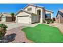 Warm two-story home with front yard landscaping, stone ground cover, and front-facing two-car garage at 13620 N 82Nd Ln, Peoria, AZ 85381