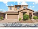 Beautiful two-story home featuring a stone facade, a two-car garage, and manicured landscaping at 15711 S 11Th Ave, Phoenix, AZ 85045