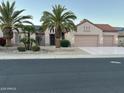 Inviting single-story home showcases desert landscaping, a three-car garage, and a welcoming front entrance at 16158 W Copper Point Ln, Surprise, AZ 85374