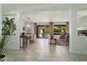 Open-concept living and dining areas with tile floors, neutral decor, and access to the outdoor patio at 16158 W Copper Point Ln, Surprise, AZ 85374
