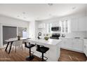 Bright, modern kitchen with white cabinets, an island with seating, and stainless steel appliances at 16875 N 12Th St # 13, Phoenix, AZ 85020