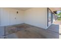 Covered carport with concrete flooring and access door to the home's side entrance and side windows at 1708 W Estrella Dr, Chandler, AZ 85224