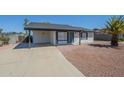 Exterior of home featuring covered parking, desert landscaping, and a front entrance with a blue door at 1708 W Estrella Dr, Chandler, AZ 85224