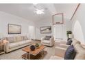 Bright living room with vaulted ceiling, skylight, modern furnishings, and neutral decor at 18814 N 33Rd Ave, Phoenix, AZ 85027