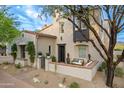 Charming home with desert landscaping, a brick patio, and a lovely tree in the front yard at 19829 N 97Th St, Scottsdale, AZ 85255