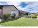 Lush backyard with manicured lawn, covered patio, and vibrant plants perfect for outdoor relaxation at 29214 N 19Th Ln, Phoenix, AZ 85085