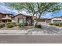 Charming single-Gathering home featuring stone accents, desert landscaping, and a welcoming two-car garage at 29214 N 19Th Ln, Phoenix, AZ 85085