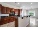 Modern kitchen features sleek granite countertops, rich wood cabinetry, and stainless steel appliances at 29214 N 19Th Ln, Phoenix, AZ 85085