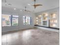 Bright living room with tile flooring, built-in shelving, and large windows offering plenty of natural light at 29214 N 19Th Ln, Phoenix, AZ 85085
