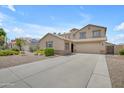 Inviting beige two-story home with a spacious driveway and desert landscaping at 3349 E Flamingo Ct, Gilbert, AZ 85297