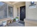 Front entryway featuring a black security door, welcome mat, and decorative plants at 3349 E Flamingo Ct, Gilbert, AZ 85297