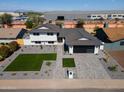 Aerial view of a modern home with a manicured lawn and elegant gray brick driveway, showcasing its prime location at 3413 N 87Th Pl, Scottsdale, AZ 85251