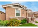 Charming home features a stone facade and landscaped yard with brick pathway for added curb appeal at 3637 E Ebano St, Gilbert, AZ 85295