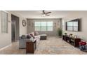 Spacious living room with large sectional sofa, ceiling fan and view at 3914 S 58Th Ln, Phoenix, AZ 85043