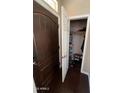 A foyer with an open closet area and rich dark wood door at 4016 E Western Star Blvd, Phoenix, AZ 85044