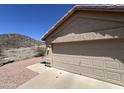 Attached two-car garage with neutral door, concrete driveway, and desert landscaping at 4016 E Western Star Blvd, Phoenix, AZ 85044