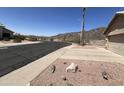 Street view of the home showing the corner lot and native landscaping at 4016 E Western Star Blvd, Phoenix, AZ 85044