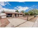 Single-story home with long driveway leading to the house; front yard features a small bricked area at 4144 N 29Th Ave, Phoenix, AZ 85017