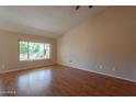 Spacious living room features wood floors, large window, and neutral wall color at 4349 W Cielo Grande --, Glendale, AZ 85310