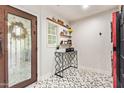 Bright entryway featuring decorative tile flooring, a stylish console table, and a unique glass-paneled front door at 4419 N 24Th Way, Phoenix, AZ 85016